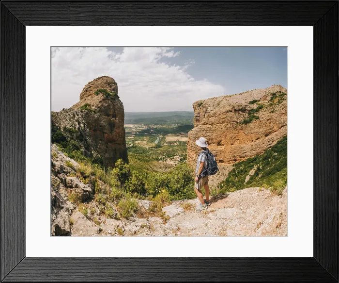 Framed Print : A young athletic woman stops at viewpoint along the Riglos rock track Framed Print : A young athletic woman stops at viewpoint along the Riglos rock track