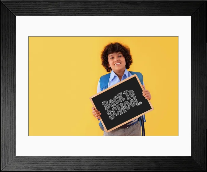 Framed Print : A BOY IN SCHOOL UNIFORM HAPPILY DISPLAYING MESSAGE OF BACK TO SCHOOL AFTER PANDEMIC Framed Print : A BOY IN SCHOOL UNIFORM HAPPILY DISPLAYING MESSAGE OF BACK TO SCHOOL AFTER PANDEMIC