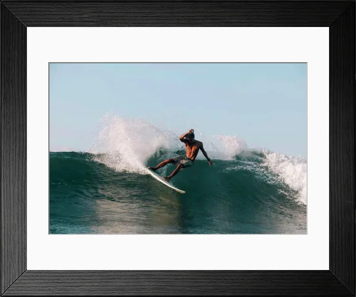Framed Print : Surfer on a wave at sunny day