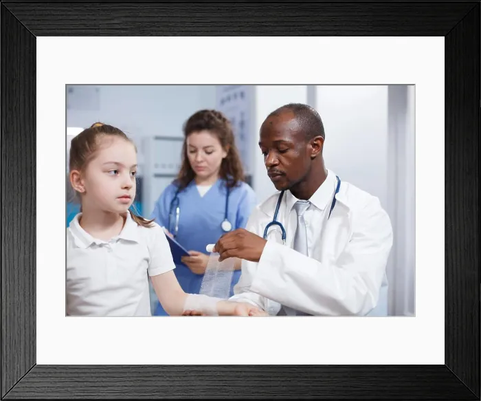 Framed Print : Child being treated by doctor and nurse Framed Print : Child being treated by doctor and nurse