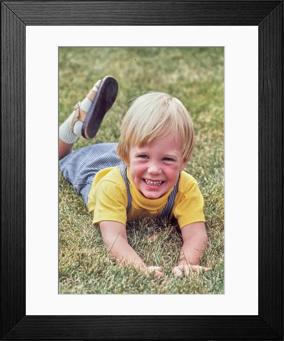 Framed Print : Vintage Photograph. Smiling child enjoying a sunny day on the grass Framed Print : Vintage Photograph. Smiling child enjoying a sunny day on the grass