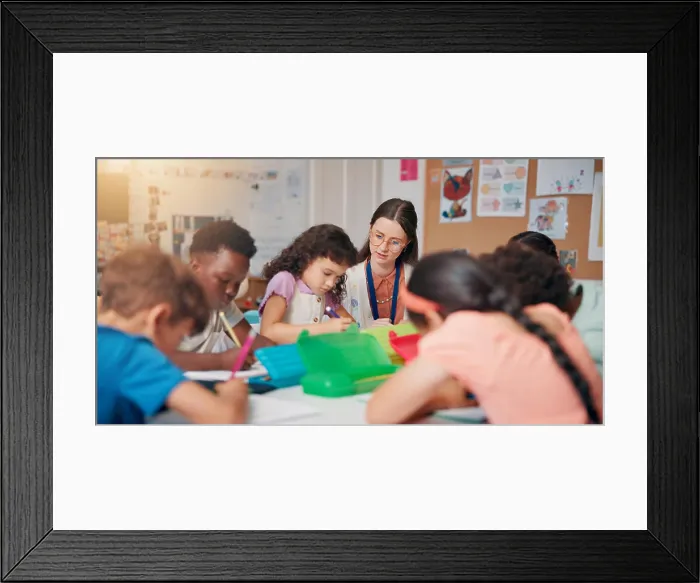 Framed Print : Writing, education and teacher helping children in classroom for language development Framed Print : Writing, education and teacher helping children in classroom for language development