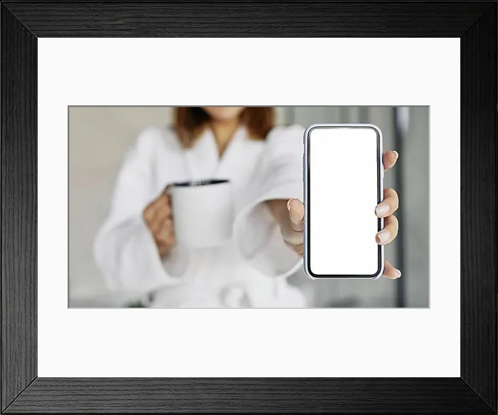 Framed Print : Beautiful woman showing blank phone. High resolution photo
