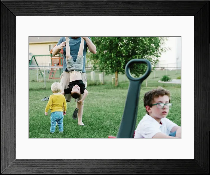 Framed Print : Father and boys playing in a suburban backyard in the summer Framed Print : Father and boys playing in a suburban backyard in the summer