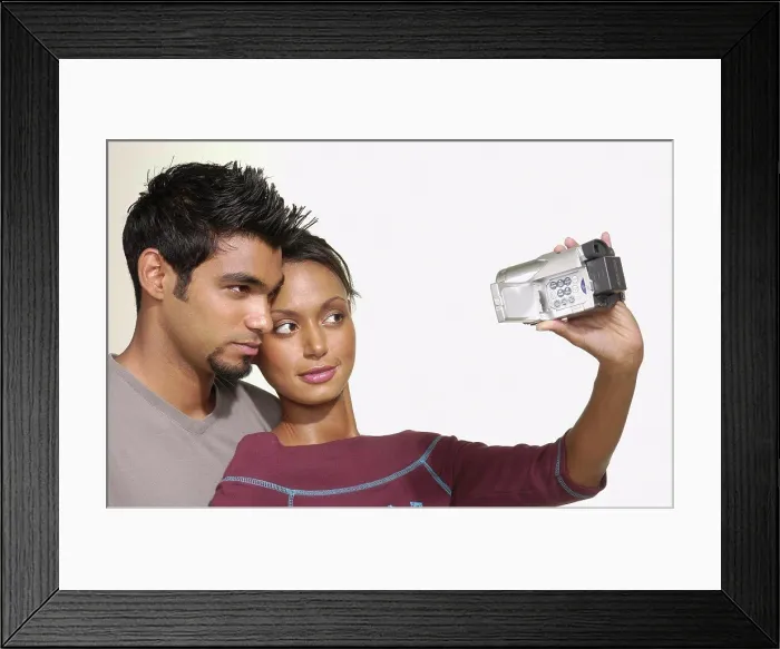 Framed Print : Couple using video camera Framed Print : Couple using video camera
