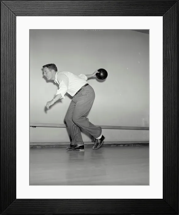 Framed Print : Vintage photograph. Side view of man throwing bowling ball down lane Framed Print : Vintage photograph. Side view of man throwing bowling ball down lane
