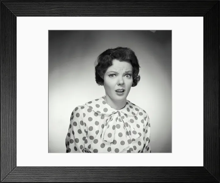 Framed Print : Vintage Photograph. Brunette woman wearing polka dot blouse looking at camera with shocked expression Framed Print : Vintage Photograph. Brunette woman wearing polka dot blouse looking at camera with shocked expression