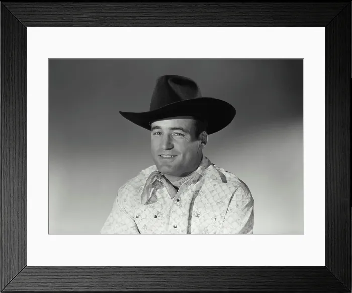 Framed Print : Vintage Photograph. Man sits for studio portrait smiling in black cowboy hat and bandana