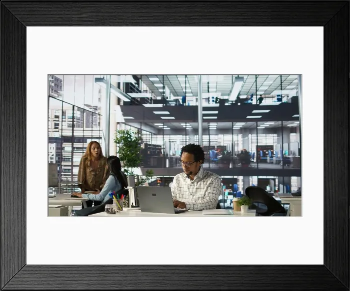 Framed Print : Skilled businessman at his office desk working on report writing
