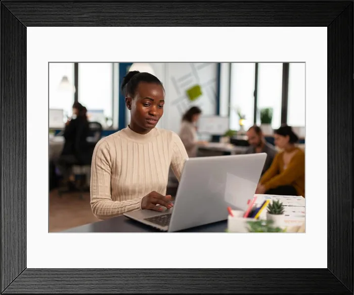 Framed Print : Black manager reading tasks on laptop Framed Print : Black manager reading tasks on laptop