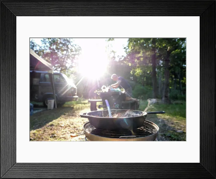 Framed Print : man setting up dinner at campground food on stove