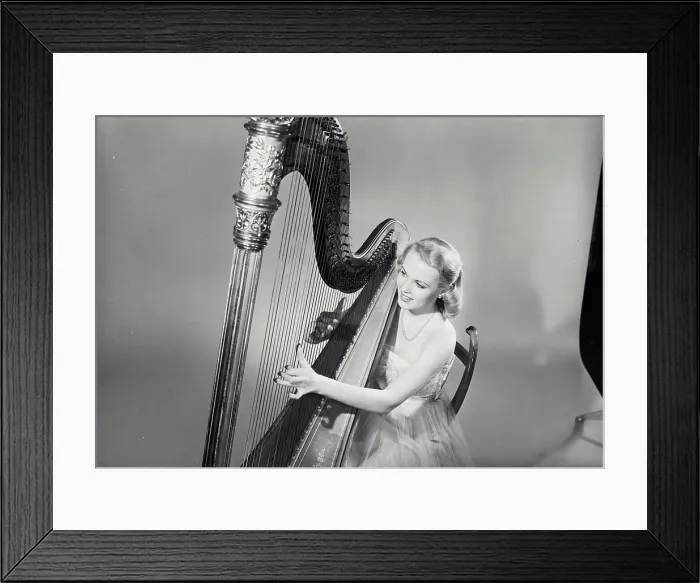 Framed Print : Vintage Photograph. Diane Williams. Model Released. Woman in dress smiling and playing Grand Pedal Harp. Frame 5