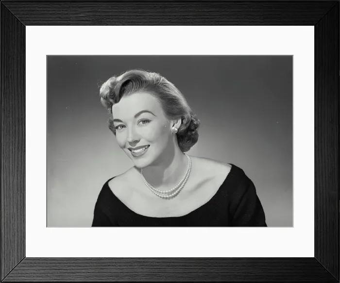 Framed Print : Vintage Photograph. Woman in low cut blouse and pearl necklace smiling wide at camera