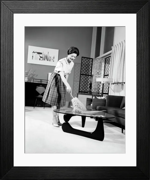 Framed Print : 1950S Woman Wearing A White Blouse & Plaid Skirt Dusting With A Feather Duster A Glass Top Coffee Table Framed Print : 1950S Woman Wearing A White Blouse & Plaid Skirt Dusting With A Feather Duster A Glass Top Coffee Table