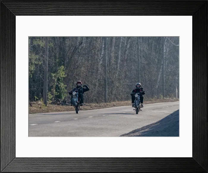 Framed Print : 15 year old boys in helmets ride their motorcycles on a rural road