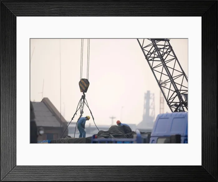 Framed Print : Two male construction workers hooking cables to a crane in a shipping yard Framed Print : Two male construction workers hooking cables to a crane in a shipping yard