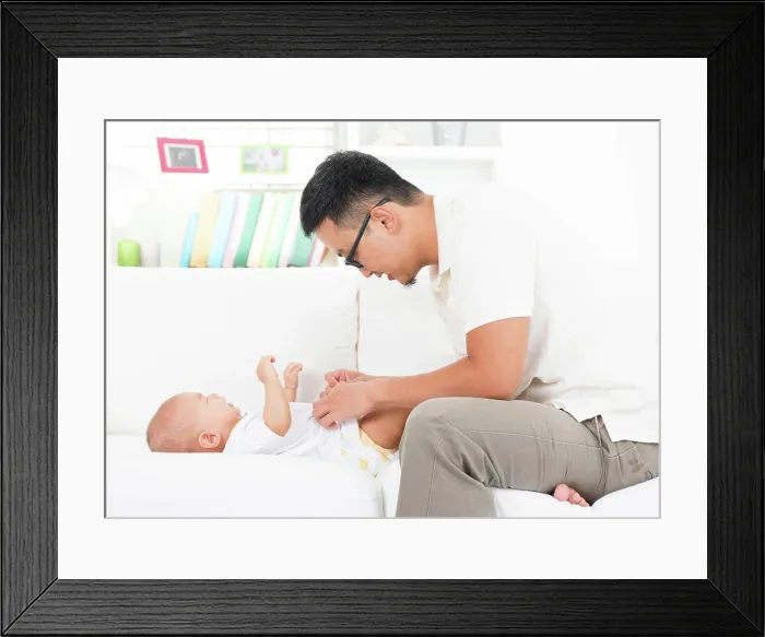 Framed Print : Father changing diaper and clothes for baby Framed Print : Father changing diaper and clothes for baby