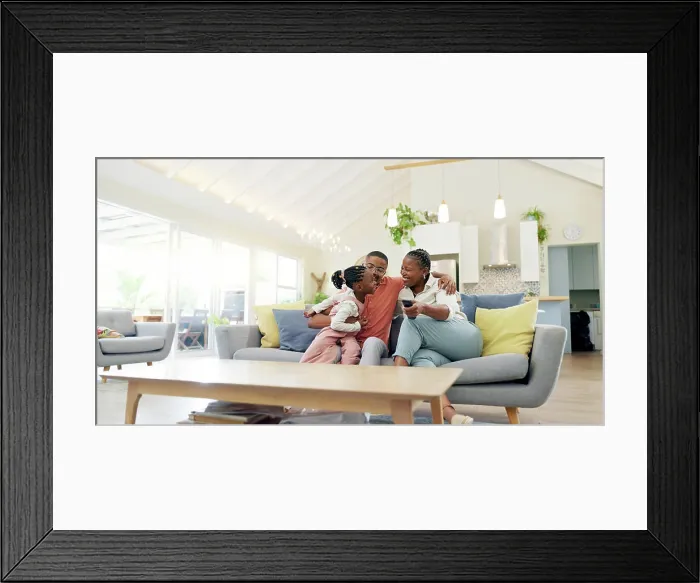 Framed Print : Support, black family on sofa and in living room of their home happy together smiling