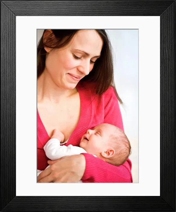 Framed Print : One month old baby sleeping in mother's arms Framed Print : One month old baby sleeping in mother's arms