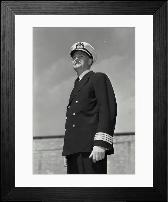 Framed Print : Vintage Photograph. Man in captains uniform standing and looking off camera and smiling Framed Print : Vintage Photograph. Man in captains uniform standing and looking off camera and smiling