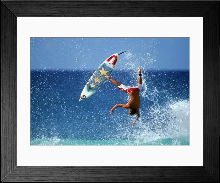 Framed Print : Rear view of a man falling from a surfboard Framed Print : Rear view of a man falling from a surfboard