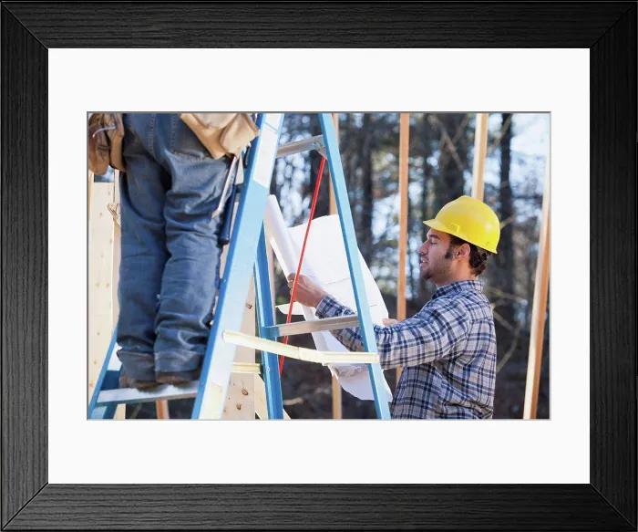 Framed Print : Carpenter explaining house plans Framed Print : Carpenter explaining house plans