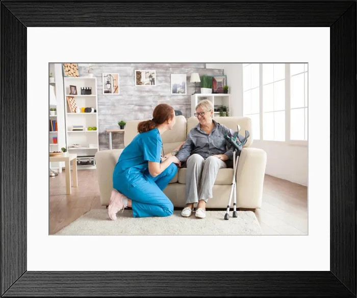 Framed Print : Female nurse talking with an old woman
