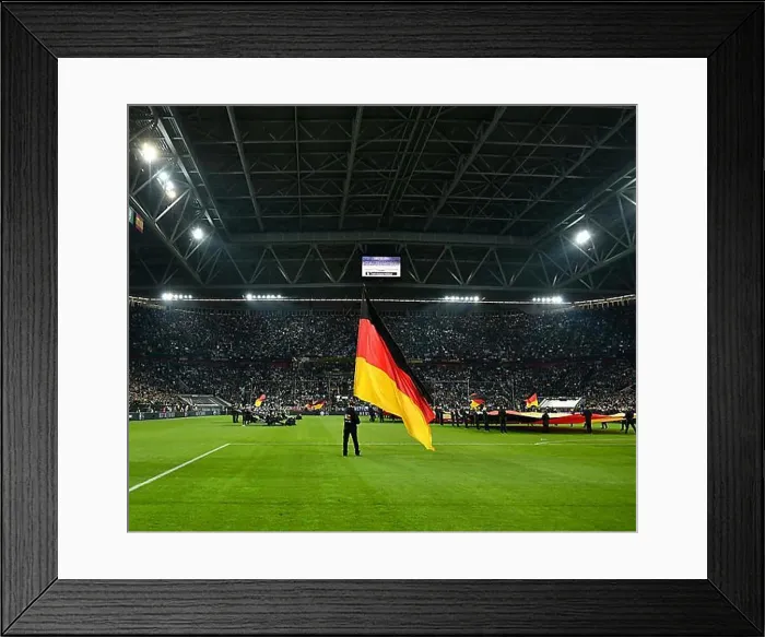 Framed Print : Atmospheric flag wavers with German flag in front of the start of the football match Framed Print : Atmospheric flag wavers with German flag in front of the start of the football match