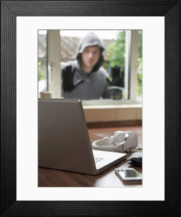 Framed Print : Burglar Looking At Valuables Through House Window