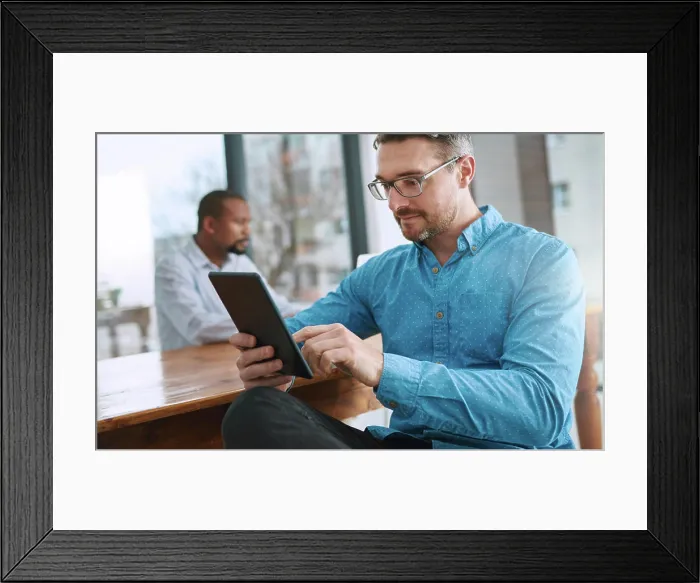 Framed Print : Tablet, reading and businessman in office with research online for finance stock market investment Framed Print : Tablet, reading and businessman in office with research online for finance stock market investment