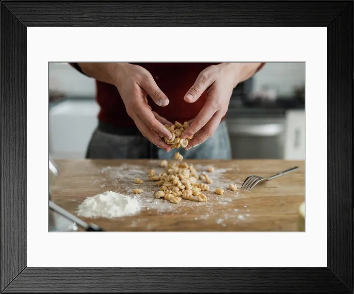 Framed Print : Masculine hands tossing and sprinkling flour on homemade pasta