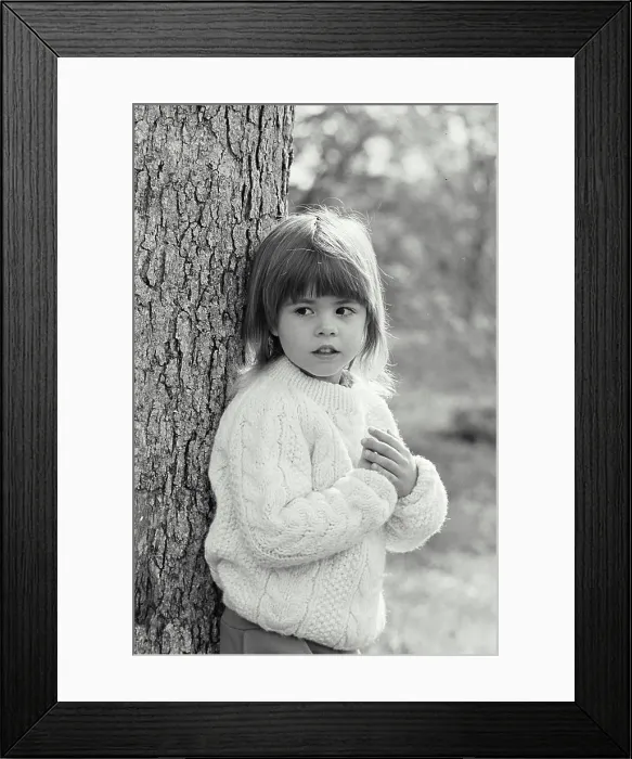 Framed Print : Vintage Photograph. A young girl leaning against a tree Framed Print : Vintage Photograph. A young girl leaning against a tree
