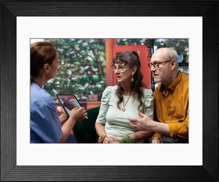 Framed Print : Professional nurse explaining a heart condition or disease to senior couple Framed Print : Professional nurse explaining a heart condition or disease to senior couple