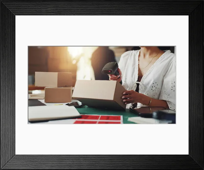 Framed Print : Hands, woman and scanner with box for distribution of orders Framed Print : Hands, woman and scanner with box for distribution of orders