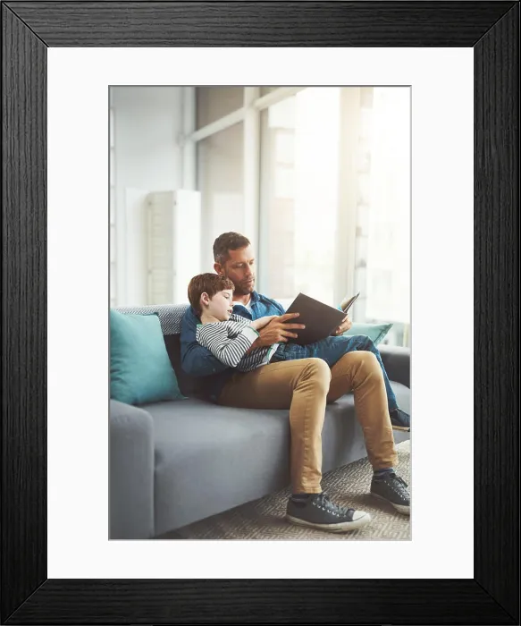 Framed Print : Home, reading book and dad with boy on sofa Framed Print : Home, reading book and dad with boy on sofa
