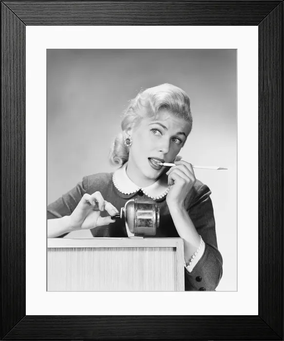 Framed Print : Thoughtful vintage office worker contemplating with pencil at desk Framed Print : Thoughtful vintage office worker contemplating with pencil at desk