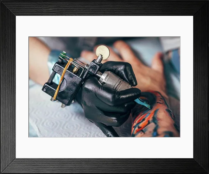 Framed Print : Cropped image of artist tattooing design on human hand Framed Print : Cropped image of artist tattooing design on human hand