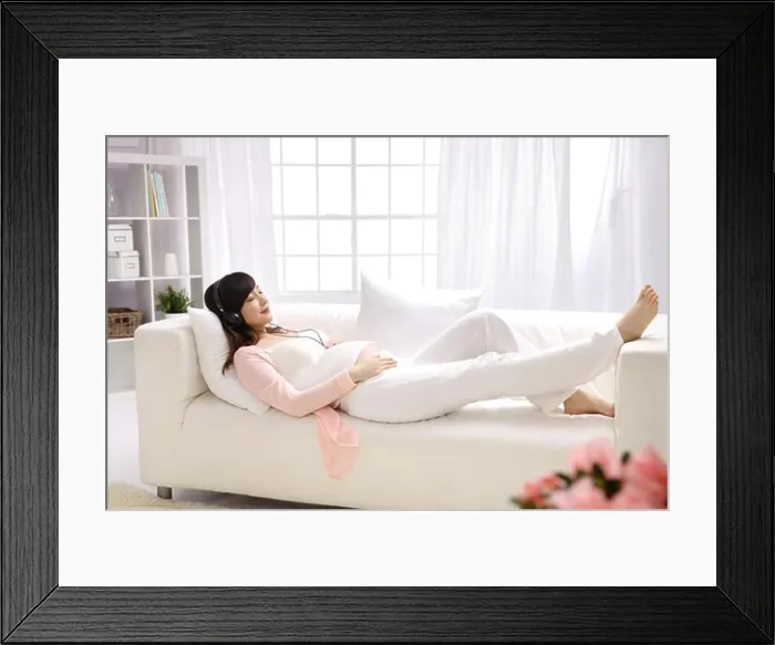 Framed Print : Pregnant woman listening to music Framed Print : Pregnant woman listening to music