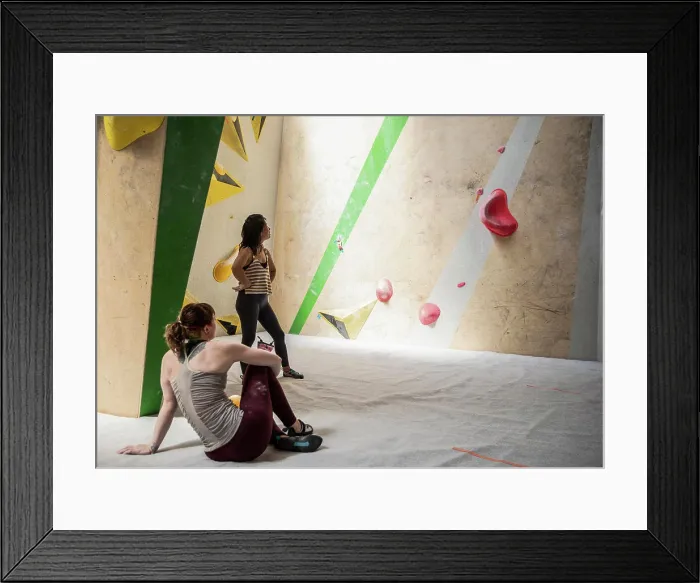 Framed Print : Female rock climbers resting at climbing wall Framed Print : Female rock climbers resting at climbing wall