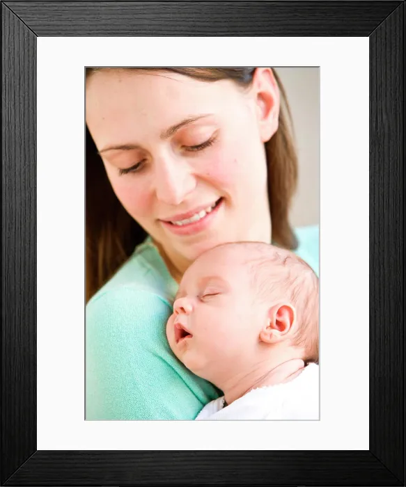 Framed Print : One month old baby sleeping in mother's arms Framed Print : One month old baby sleeping in mother's arms