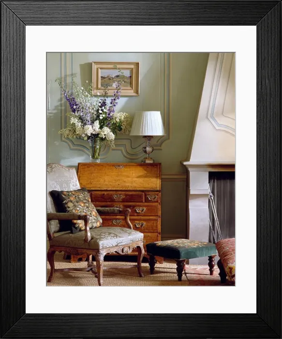 Framed Print : Armchair in front of antique bureau Framed Print : Armchair in front of antique bureau