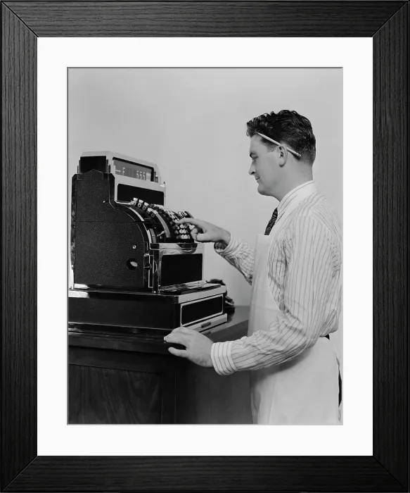 Framed Print : 1920S 1930S Man Wearing Apron Ringing Up Sale On Cash Register Framed Print : 1920S 1930S Man Wearing Apron Ringing Up Sale On Cash Register