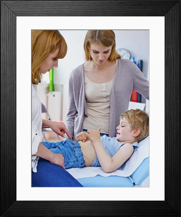 Framed Print : Doctor examining a child's abdomen Framed Print : Doctor examining a child's abdomen