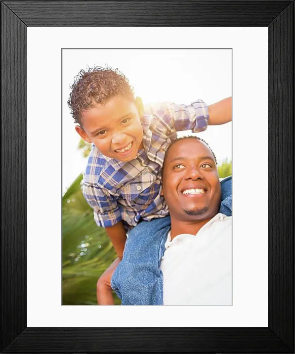 Framed Print : mixed-race son and african american father playing piggyback outdoors together Framed Print : mixed-race son and african american father playing piggyback outdoors together