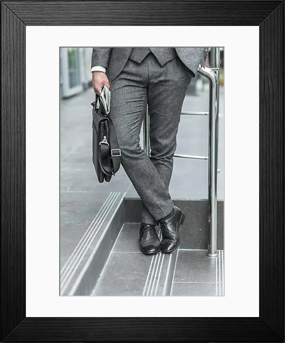 Framed Print : Low section view businessman holding shoulder bag Framed Print : Low section view businessman holding shoulder bag