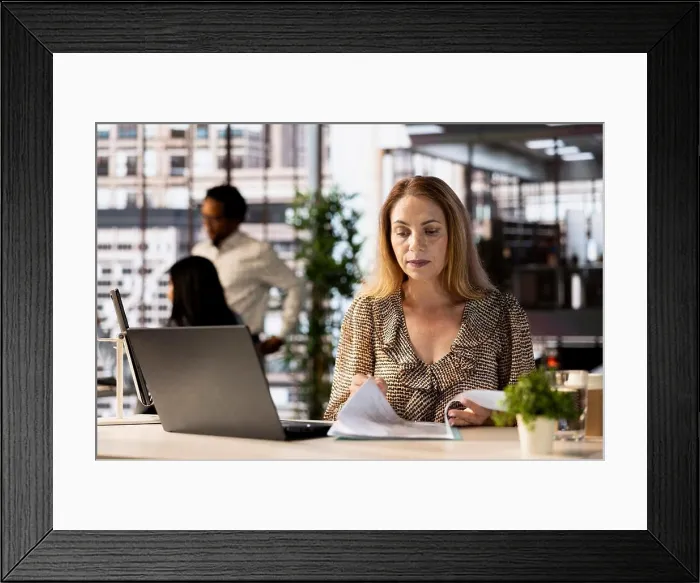 Framed Print : Female CEO engaging in project management using tech tools to set goals and objectives