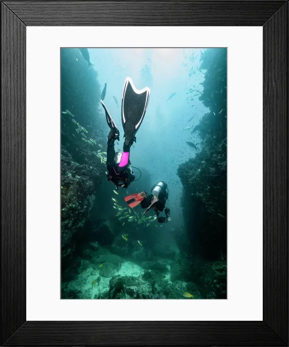 Framed Print : divers descending into the tropical waters around the Similan islands Framed Print : divers descending into the tropical waters around the Similan islands