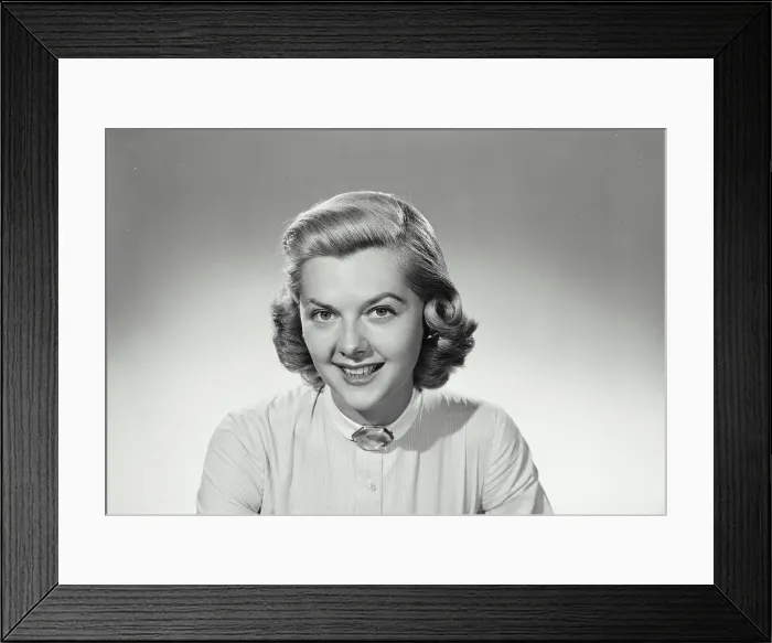 Framed Print : Vintage Photograph. Woman smiles and wears a white shirt on a white background in studio portrait Framed Print : Vintage Photograph. Woman smiles and wears a white shirt on a white background in studio portrait