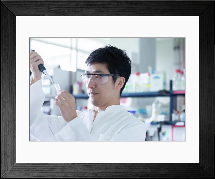 Framed Print : young scientist male chinese working in laboratory Framed Print : young scientist male chinese working in laboratory