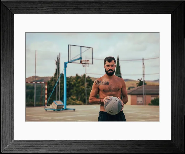 Framed Print : Close-up of a young boy holding a basketball on a court Framed Print : Close-up of a young boy holding a basketball on a court
